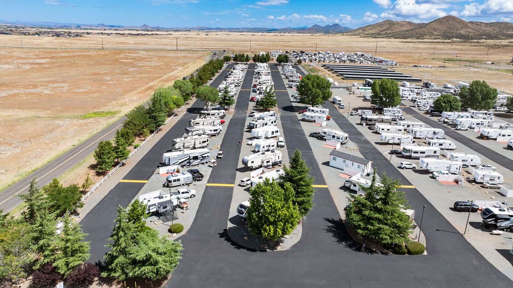 An aerial view of Fairgrounds RV Park with rows of RVs and the open Prescott Valley beyond